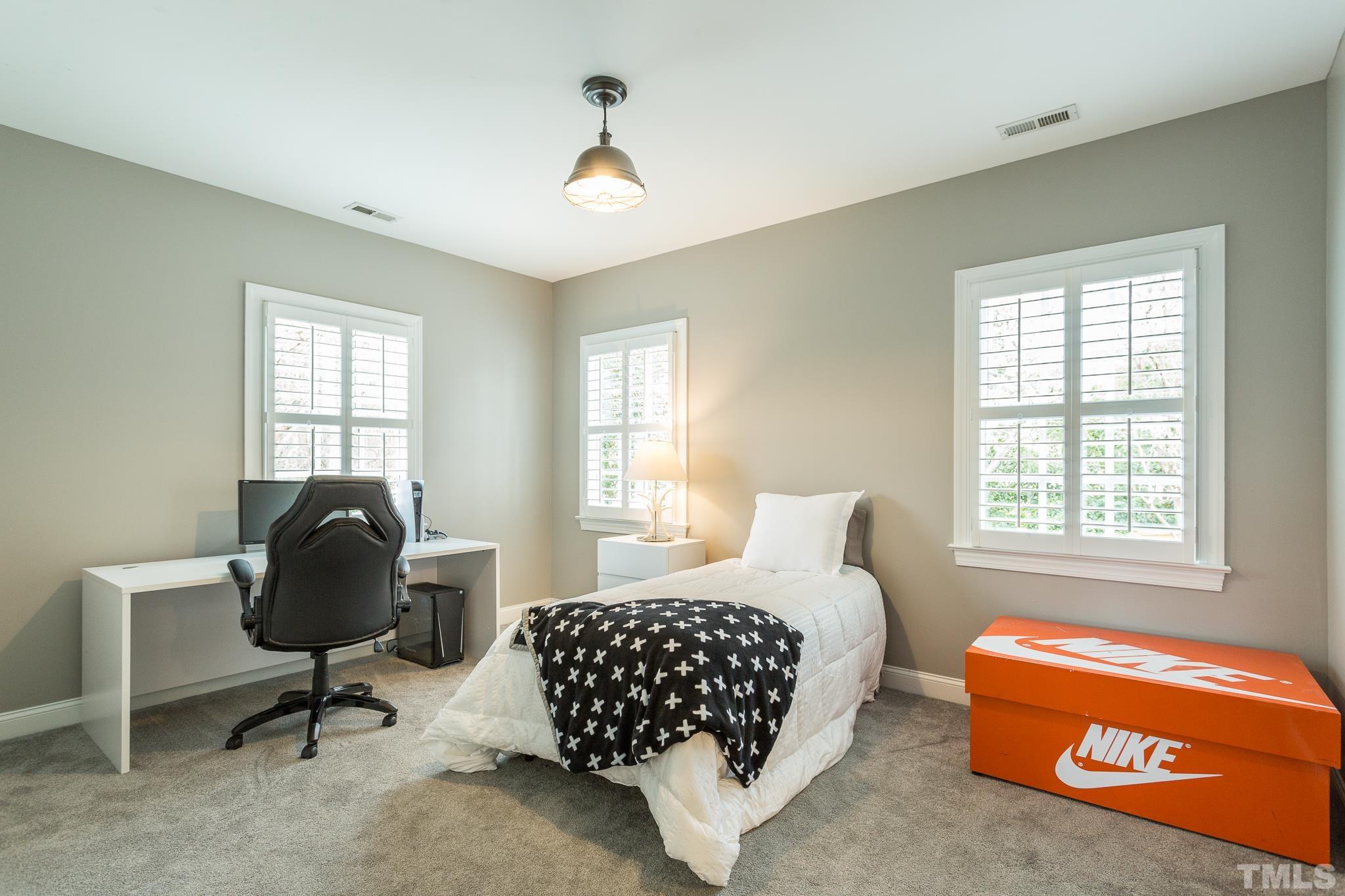 2505 Anderson Drive Raleigh, NC 27608 - Photo 15 of 30 a bedroom with a bed and a window