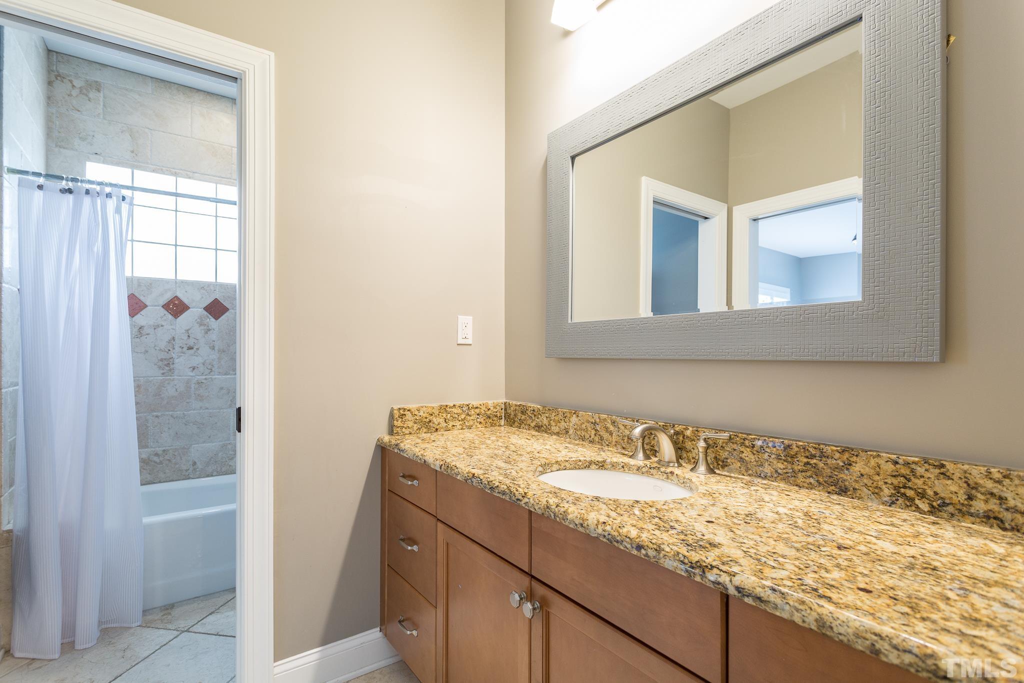2505 Anderson Drive Raleigh, NC 27608 - Photo 16 of 30 a bathroom with a granite countertop sink and a mirror