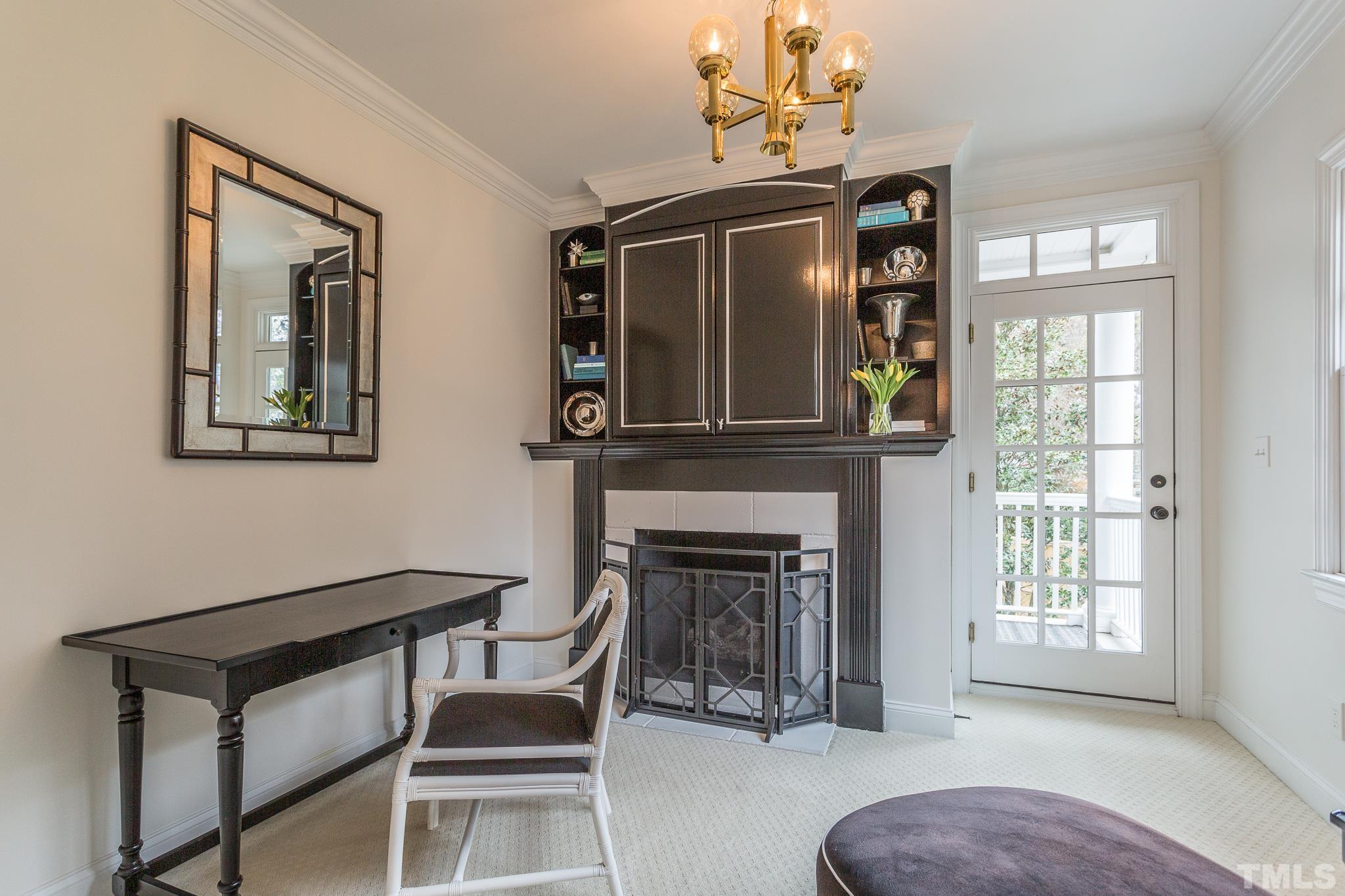 2505 Anderson Drive Raleigh, NC 27608 - Photo 20 of 30 a living room with furniture a chandelier and a fireplace