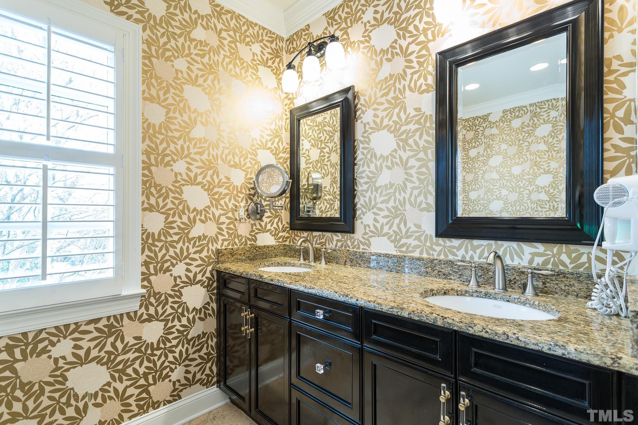 2505 Anderson Drive Raleigh, NC 27608 - Photo 22 of 30 a bathroom with a granite countertop sink a mirror and a shower