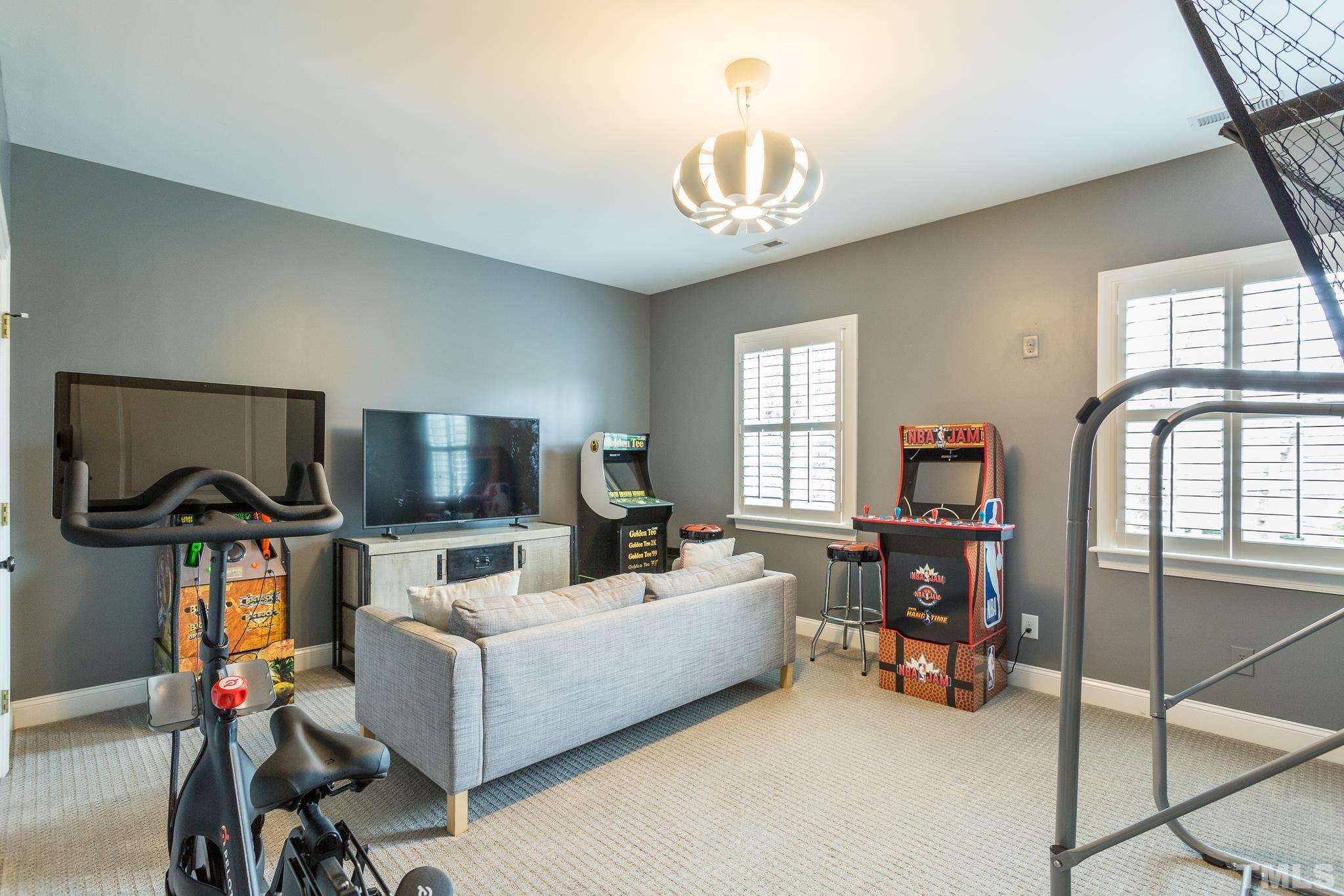2505 Anderson Drive Raleigh, NC 27608 - Photo 25 of 30 a living room with furniture a chandelier and a flat screen tv