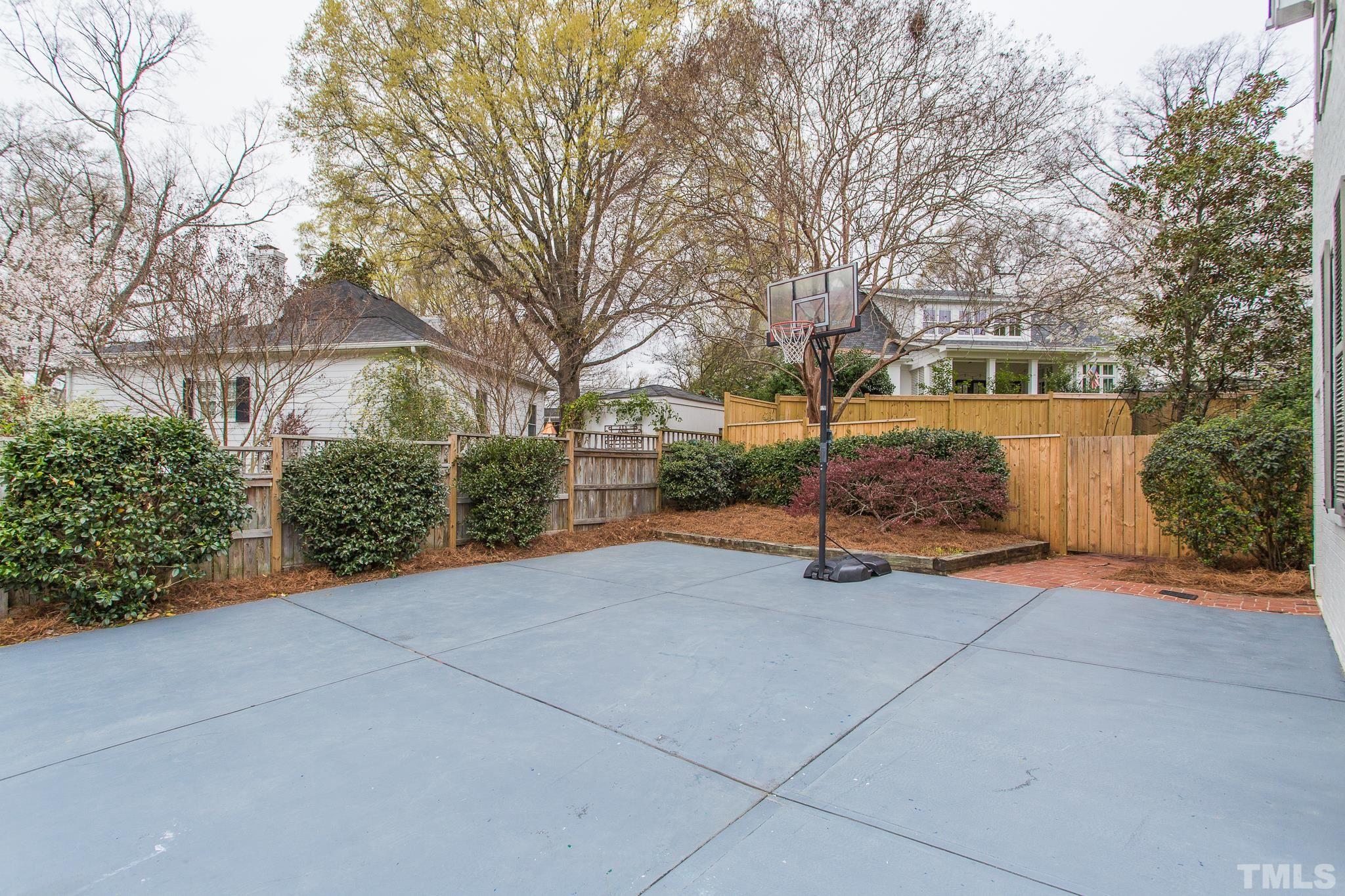 2505 Anderson Drive Raleigh, NC 27608 - Photo 28 of 30 a view of backyard with large trees and flower plants