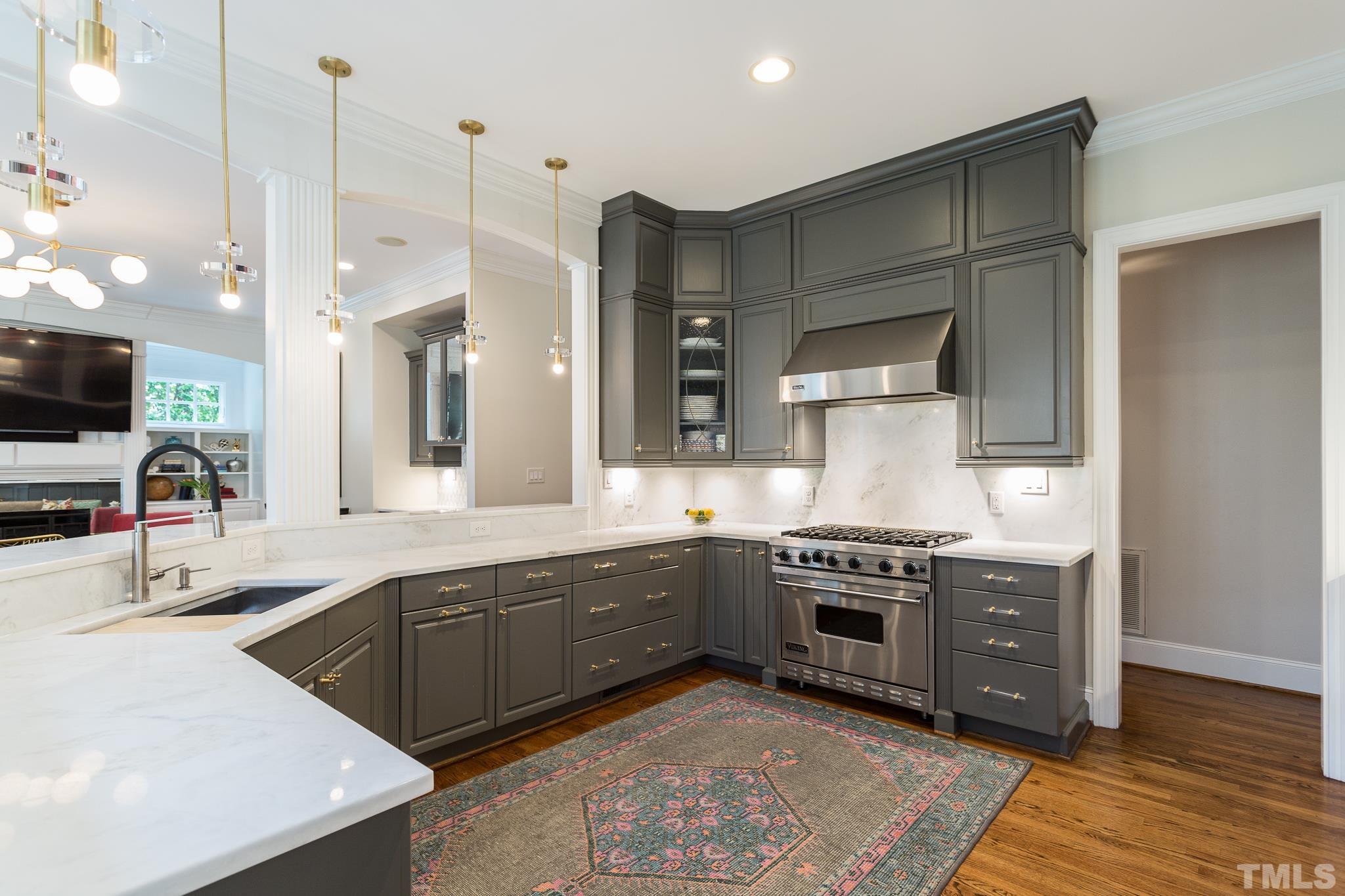 2505 Anderson Drive Raleigh, NC 27608 - Photo 10 of 30 a kitchen with stainless steel appliances granite countertop a sink a stove and a wooden floors