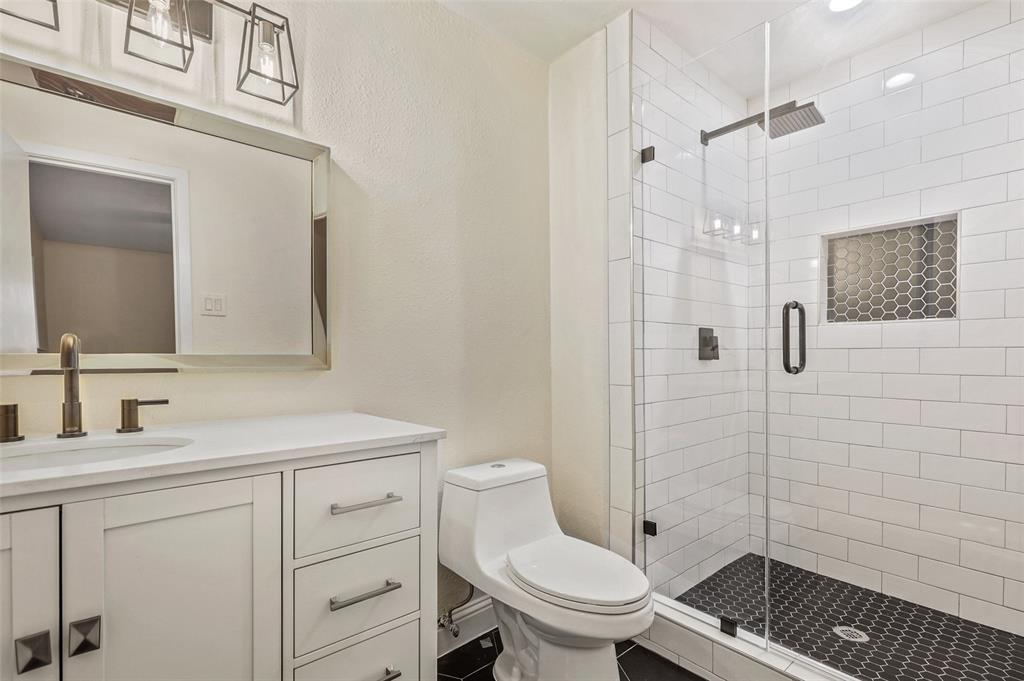 3126 Jubilee Trail Dallas, TX 75229 - Photo 18 of 38 a bathroom with a sink toilet vanity and shower