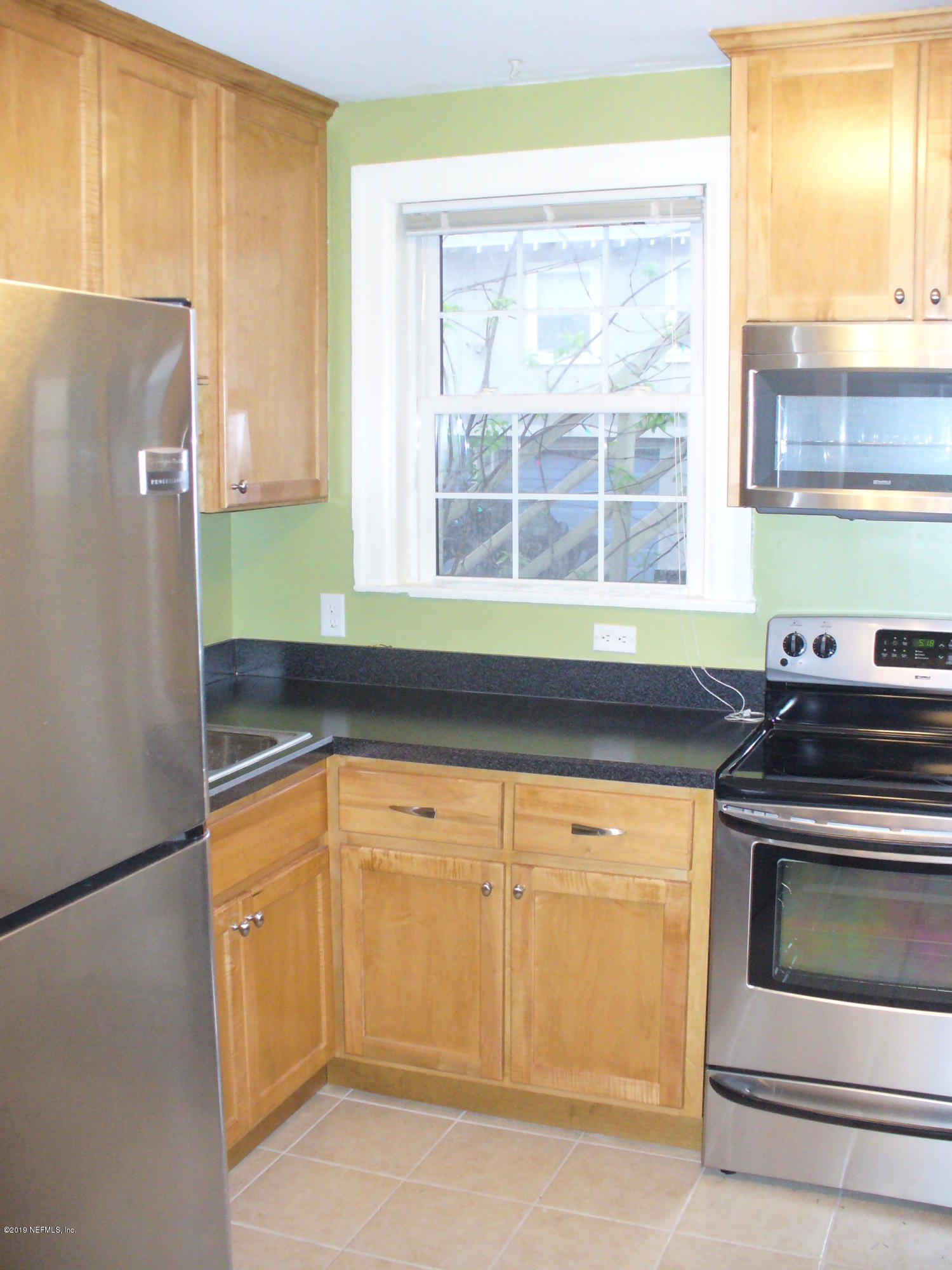 212 Oak Street Neptune Beach, FL 32266 - Photo 5 of 7 a kitchen with a sink and a refrigerator