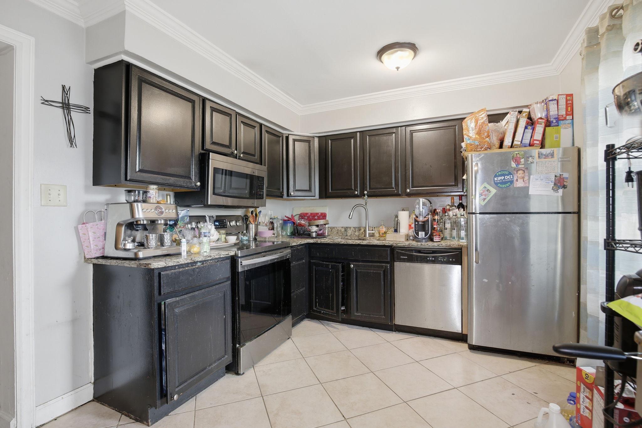 1101 Dutton Way Capitol Heights, MD 20743 - Photo 13 of 29 a kitchen with stainless steel appliances granite countertop a refrigerator sink and cabinets