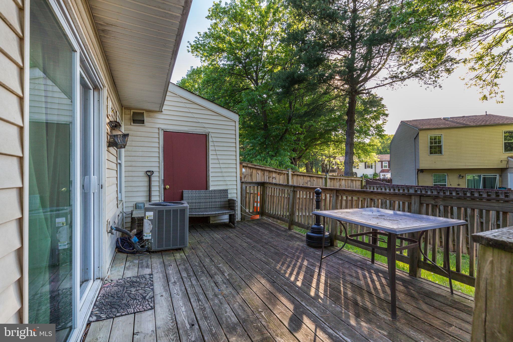 1101 Dutton Way Capitol Heights, MD 20743 - Photo 25 of 29 a view of a roof deck with table and chairs with wooden floor and fence