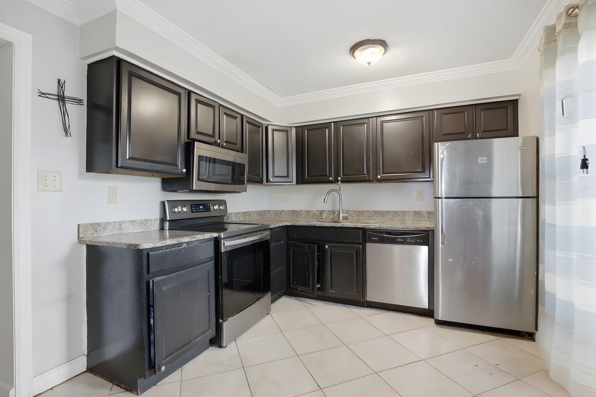 1101 Dutton Way Capitol Heights, MD 20743 - Photo 4 of 29 a kitchen with stainless steel appliances granite countertop a refrigerator stove a sink dishwasher and microwave