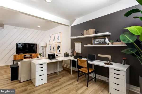 a view of a workspace with furniture and a flat screen tv
