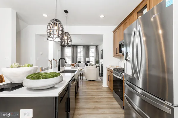 a kitchen with a sink and chandelier