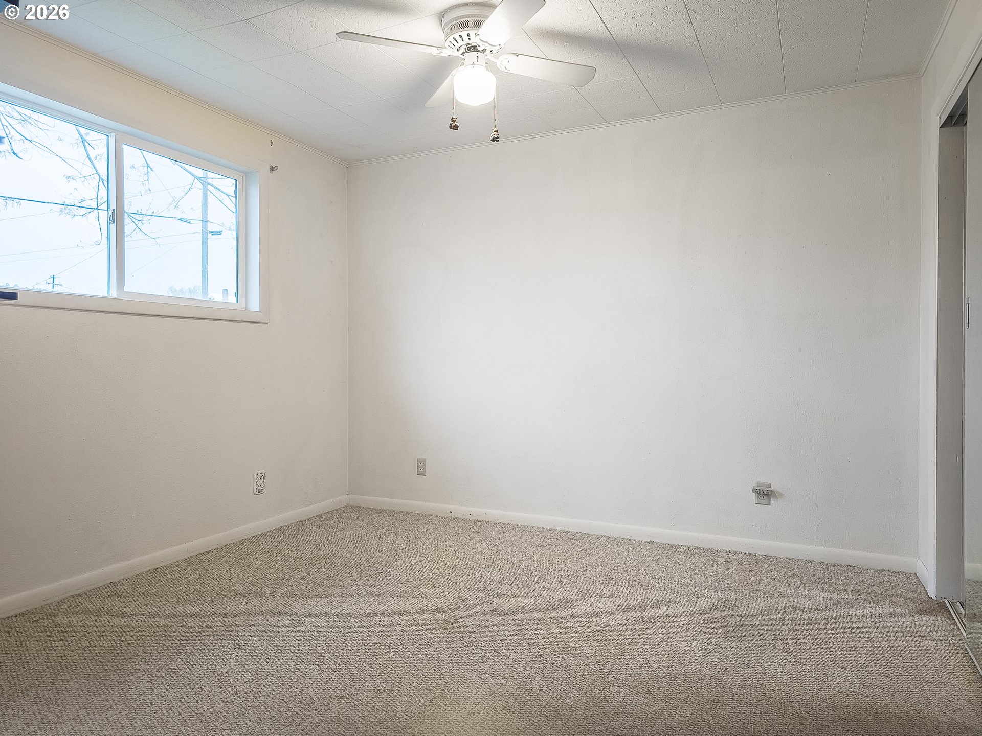 190 South 6th Street Elgin, OR 97827 - Photo 11 of 15 an empty room with a window and a fan