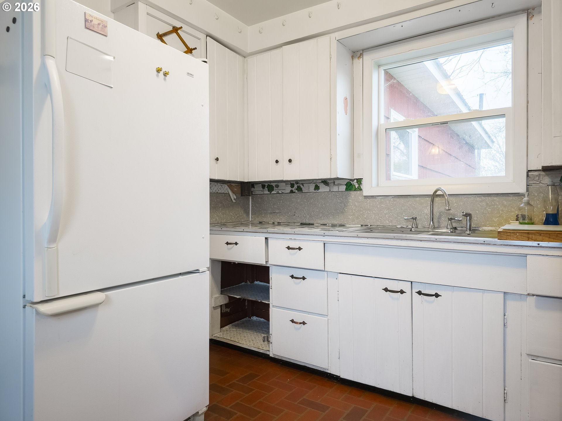 190 South 6th Street Elgin, OR 97827 - Photo 8 of 15 a kitchen with a refrigerator a sink and a window