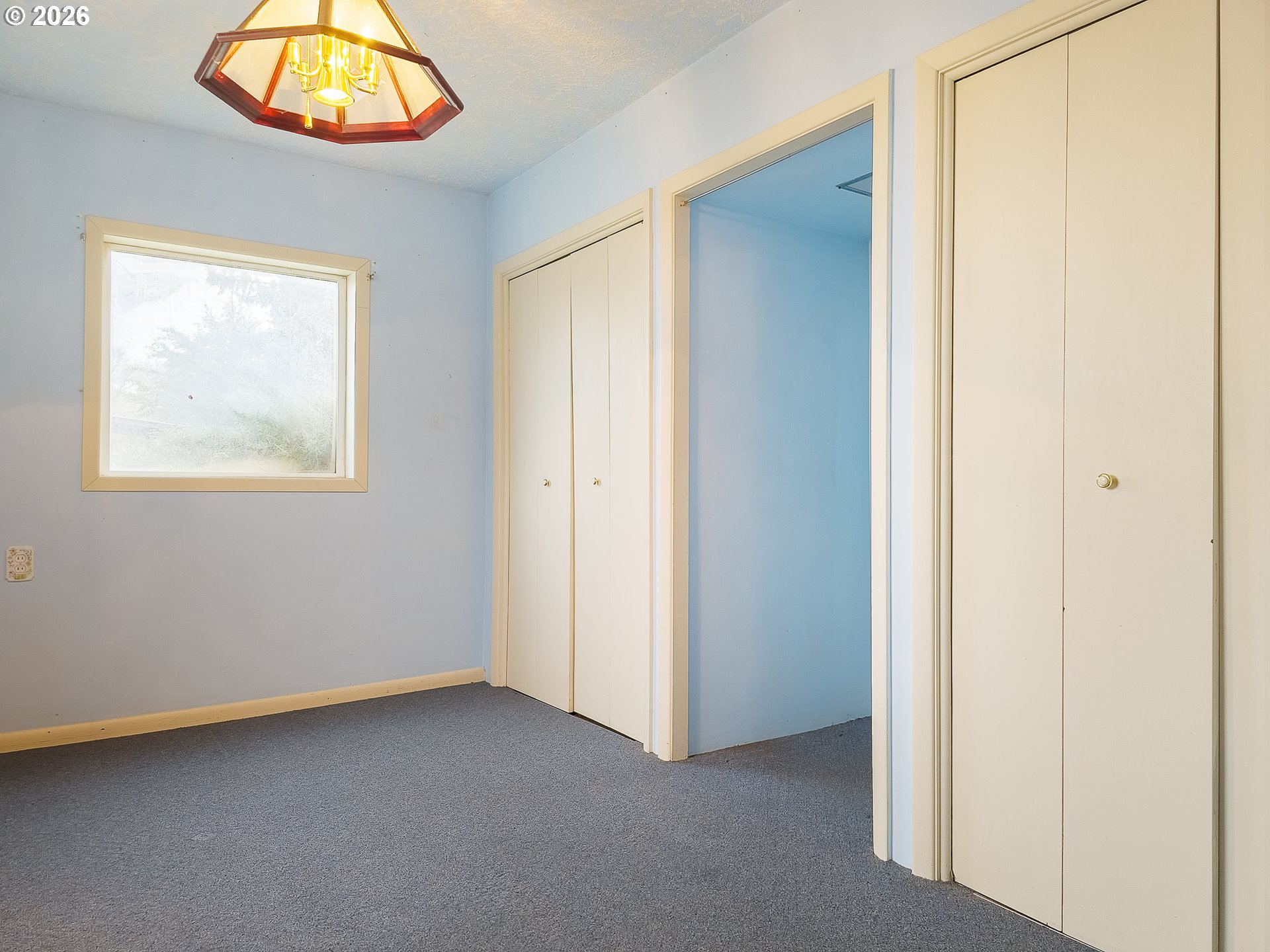 190 South 6th Street Elgin, OR 97827 - Photo 10 of 15 an empty room with a window and a chandelier