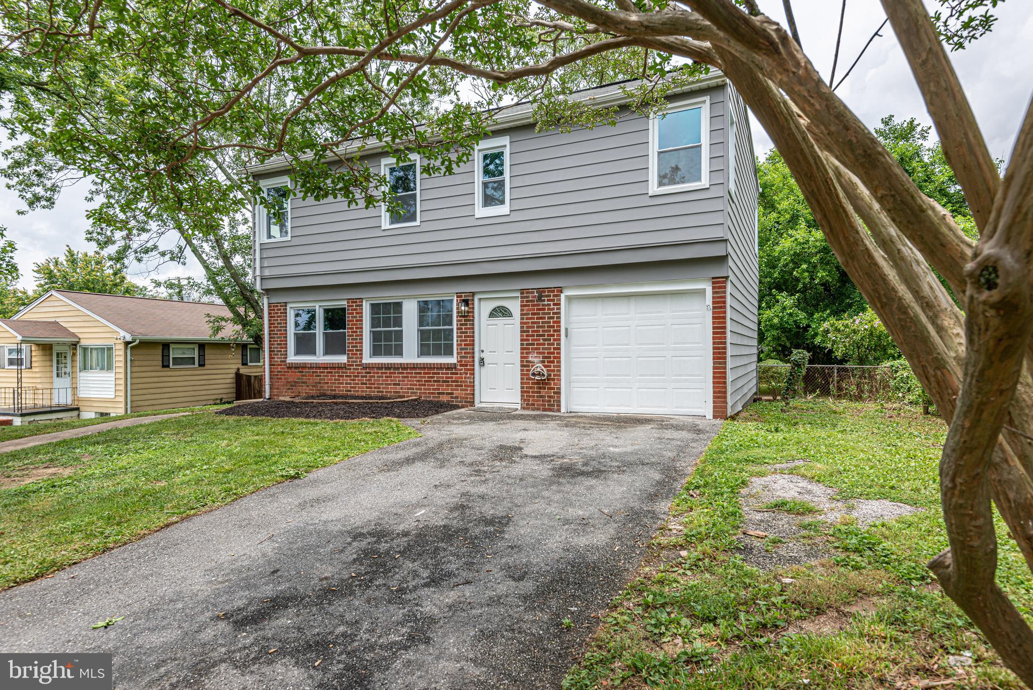 1852 Colmar Road Baltimore, MD 21207 - Photo 2 of 28 a view of a house with yard and a large tree