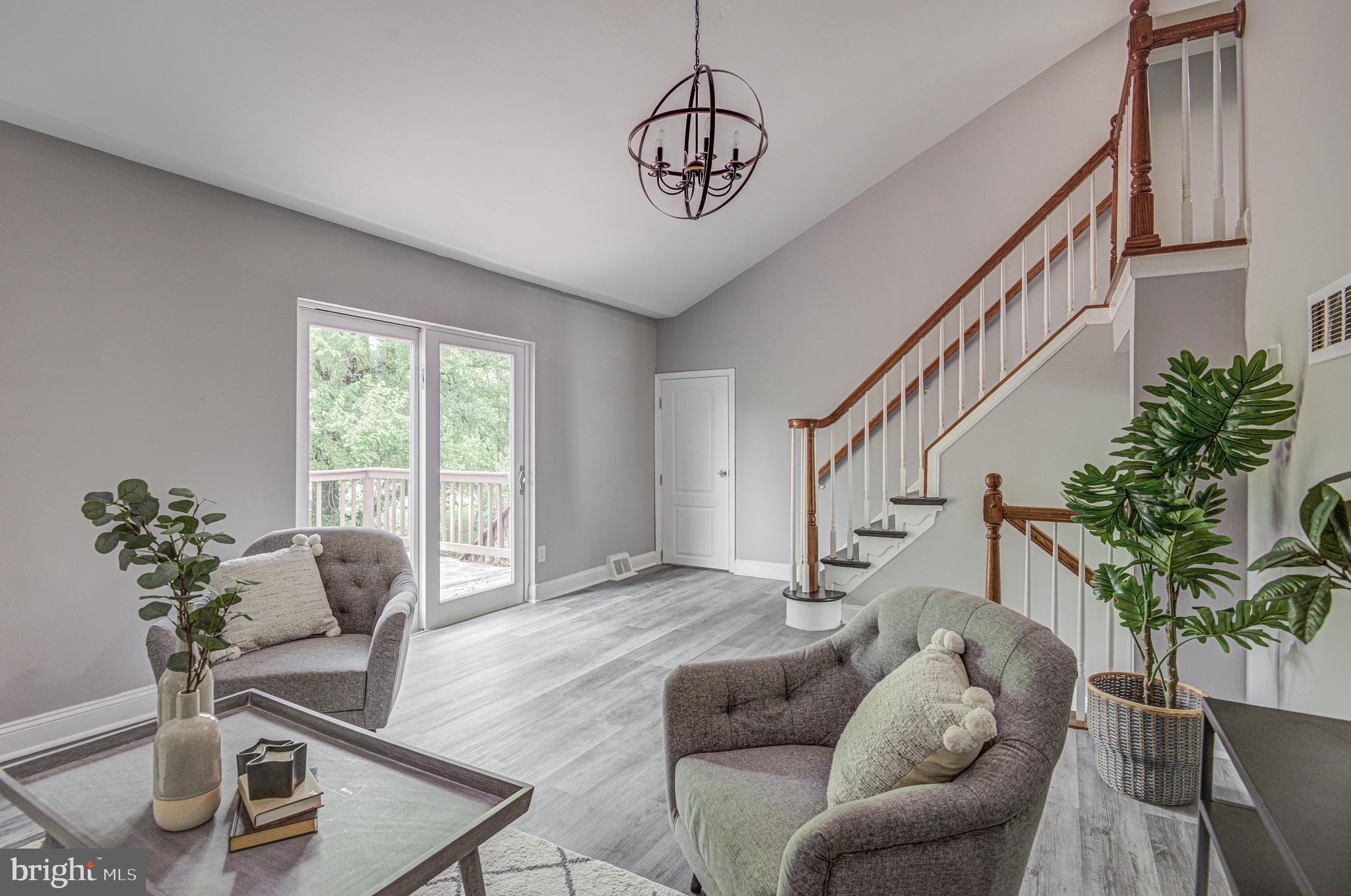1852 Colmar Road Baltimore, MD 21207 - Photo 12 of 28 a living room with furniture flowers and a potted plant
