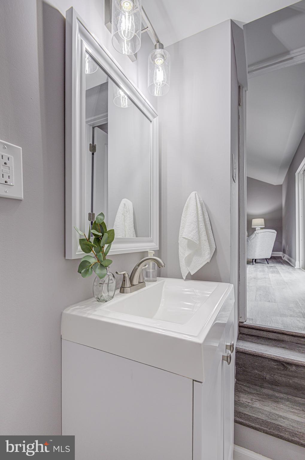1852 Colmar Road Baltimore, MD 21207 - Photo 13 of 28 a bathroom with a sink and a mirror