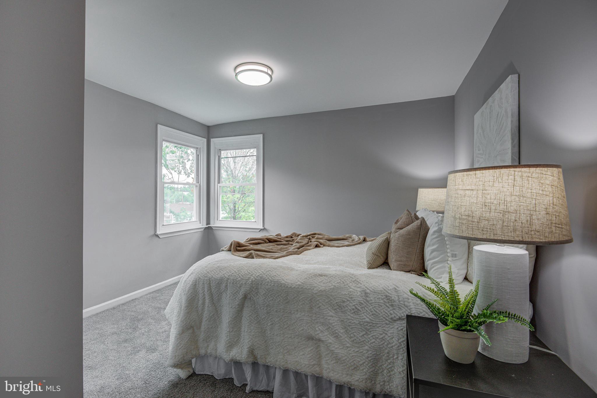 1852 Colmar Road Baltimore, MD 21207 - Photo 14 of 28 a bedroom with a bed and a potted plant