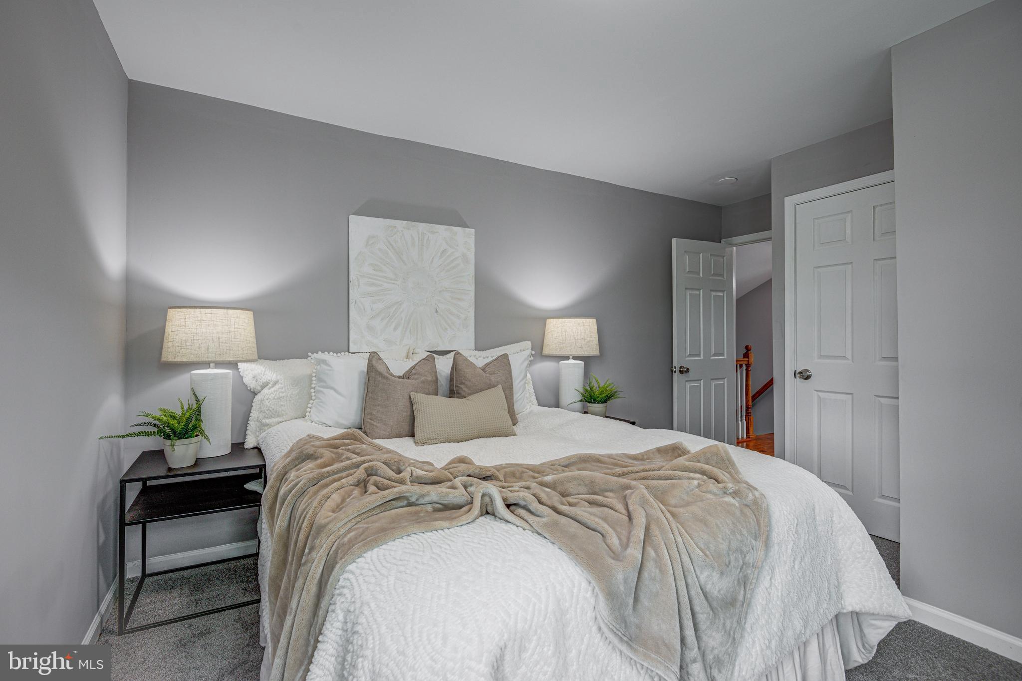 1852 Colmar Road Baltimore, MD 21207 - Photo 16 of 28 a bedroom with a bed and a potted plant