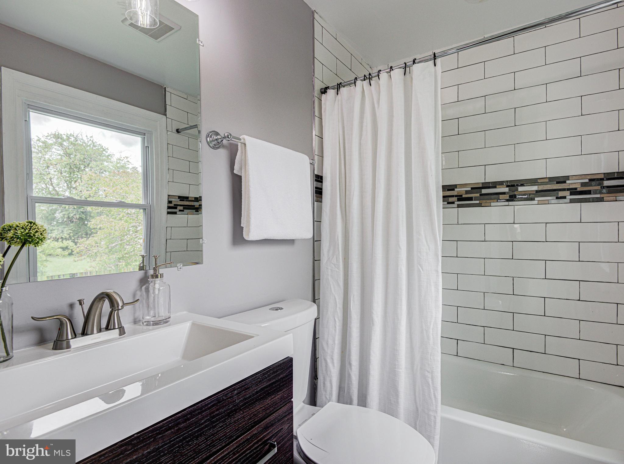 1852 Colmar Road Baltimore, MD 21207 - Photo 17 of 28 a bathroom with a sink toilet and shower
