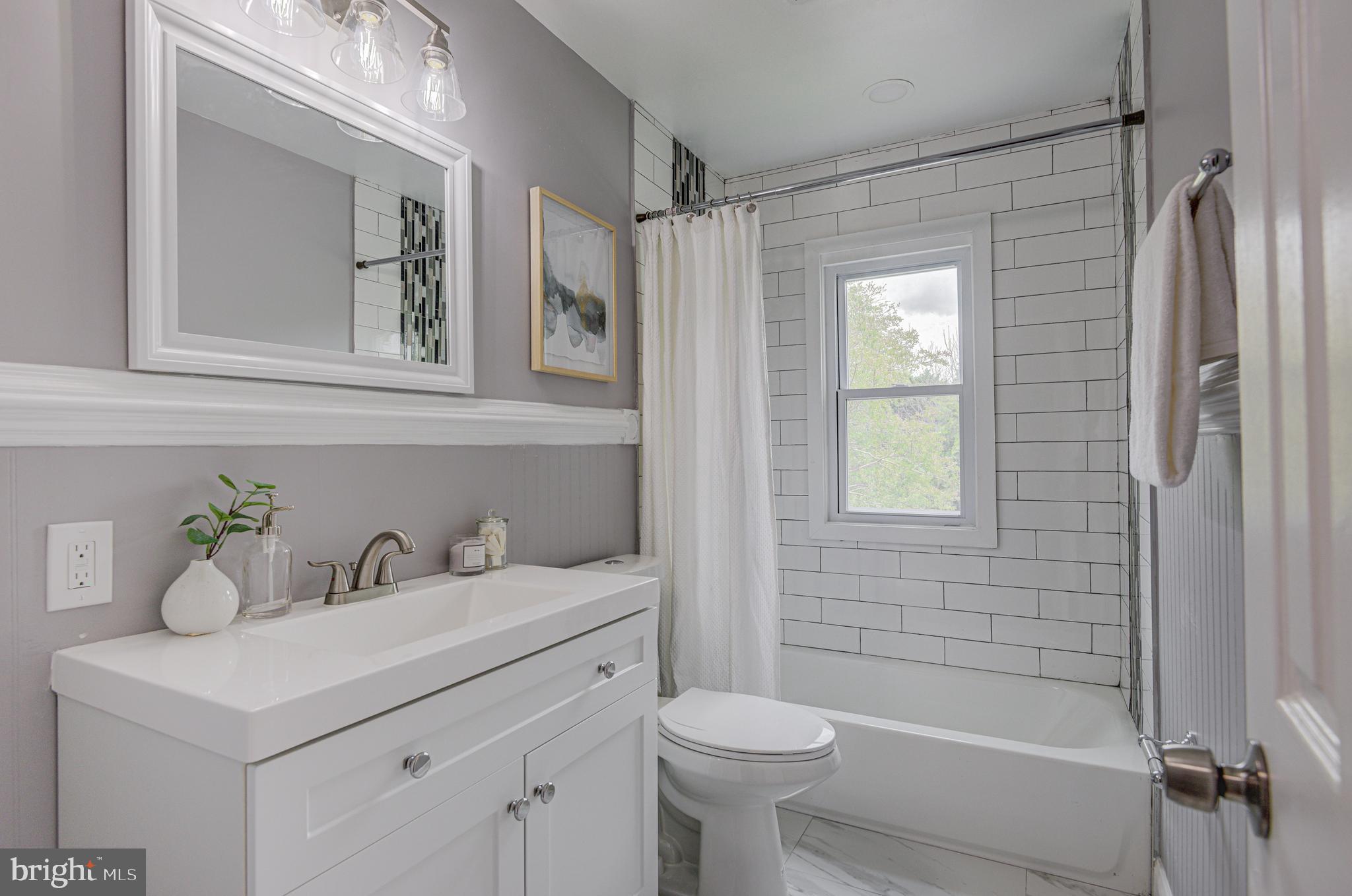 1852 Colmar Road Baltimore, MD 21207 - Photo 22 of 28 a bathroom with a sink toilet and shower