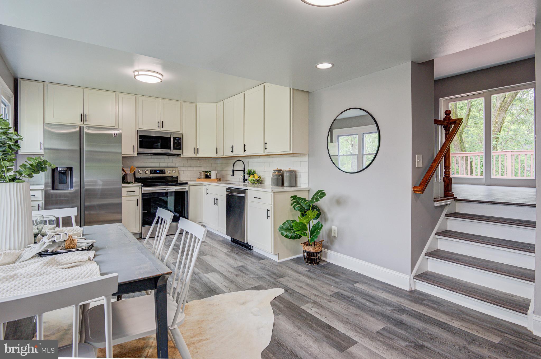 1852 Colmar Road Baltimore, MD 21207 - Photo 5 of 28 a living room with stainless steel appliances furniture a rug and a window