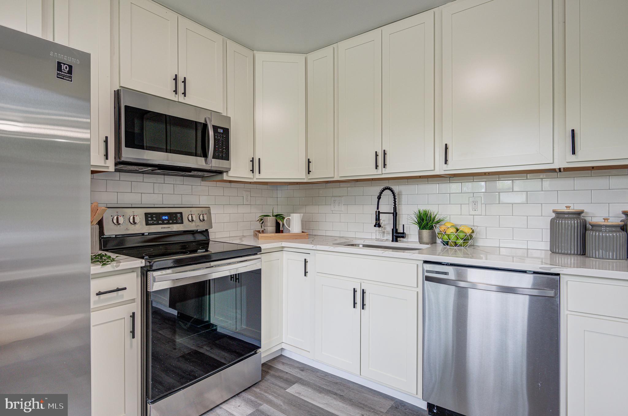 1852 Colmar Road Baltimore, MD 21207 - Photo 7 of 28 a kitchen with stainless steel appliances granite countertop a sink a stove and cabinets