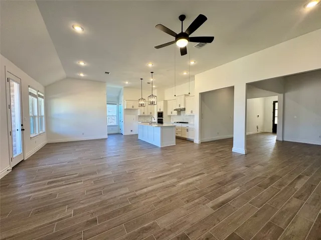a view of a kitchen with a refrigerator and a chandelier