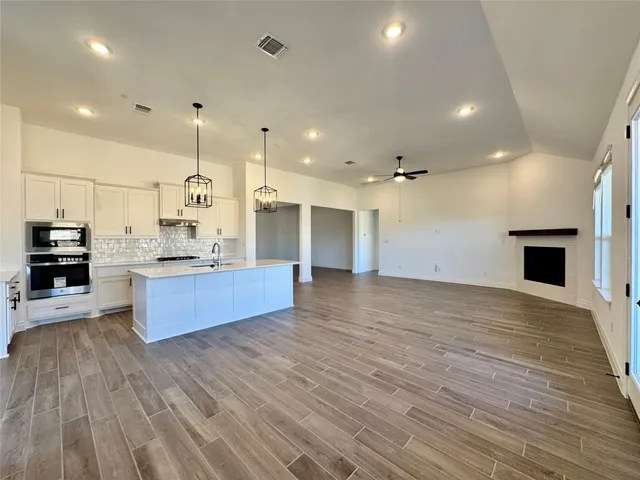 a view of kitchen with cabinets and wooden floor