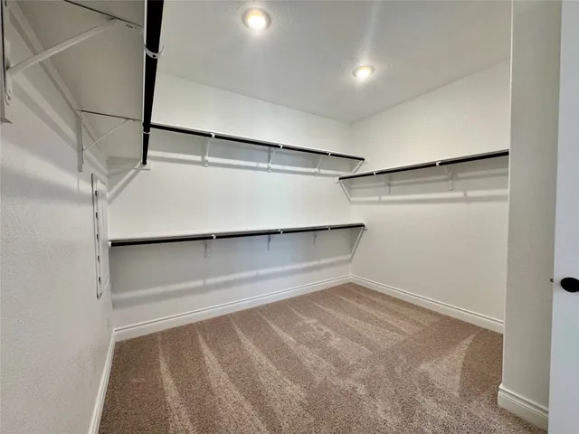 a spacious bathroom with a tub sink shower and mirror