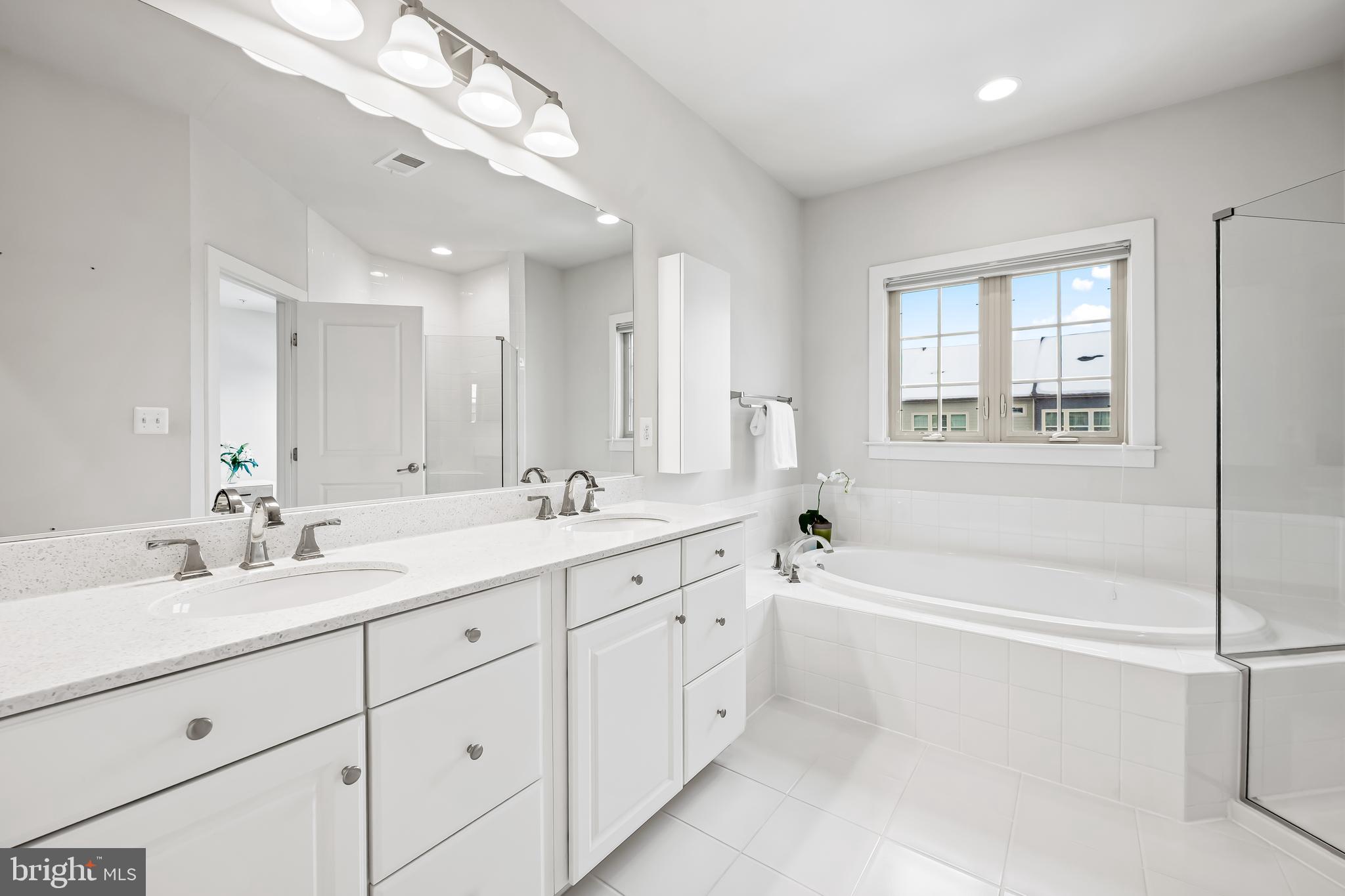 34 Wedge Way, Unit 10 Pikesville, MD 21208 - Photo 32 of 48 Luxe primary white bathroom; nickel fixtures