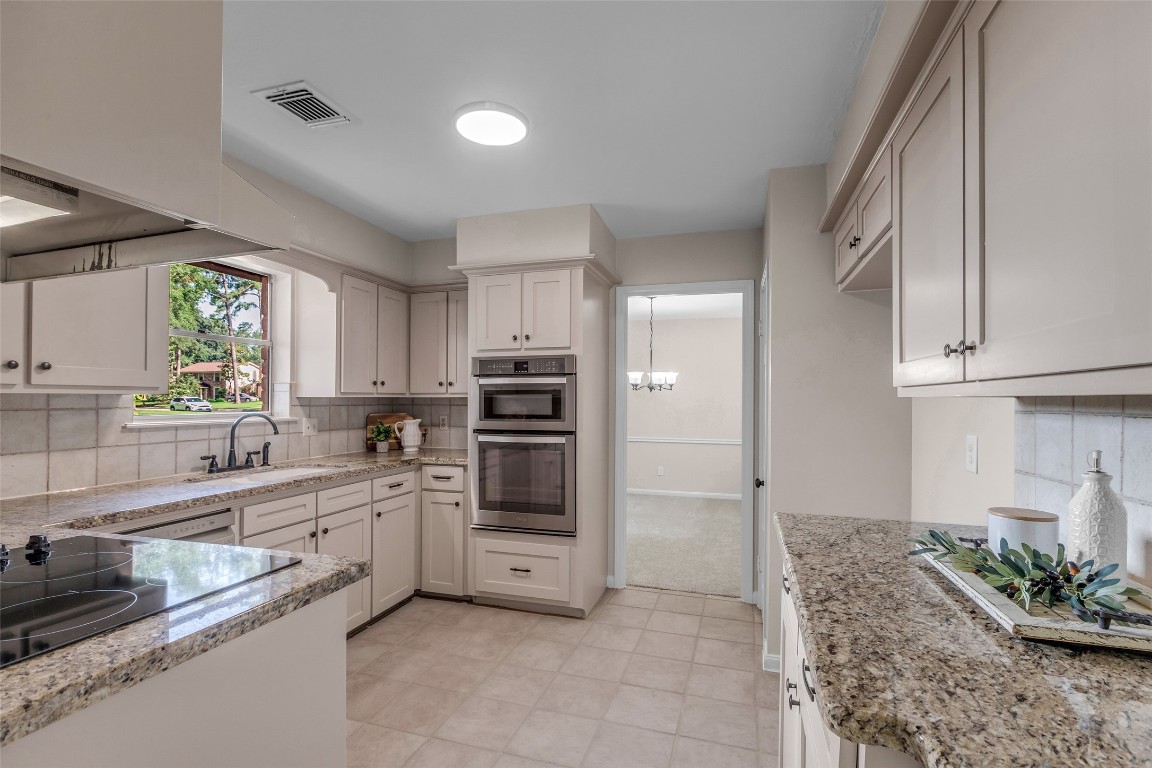 6415 Bayonne Drive Spring, TX 77389 - Photo 11 of 40 a kitchen with stainless steel appliances a sink cabinets and window
