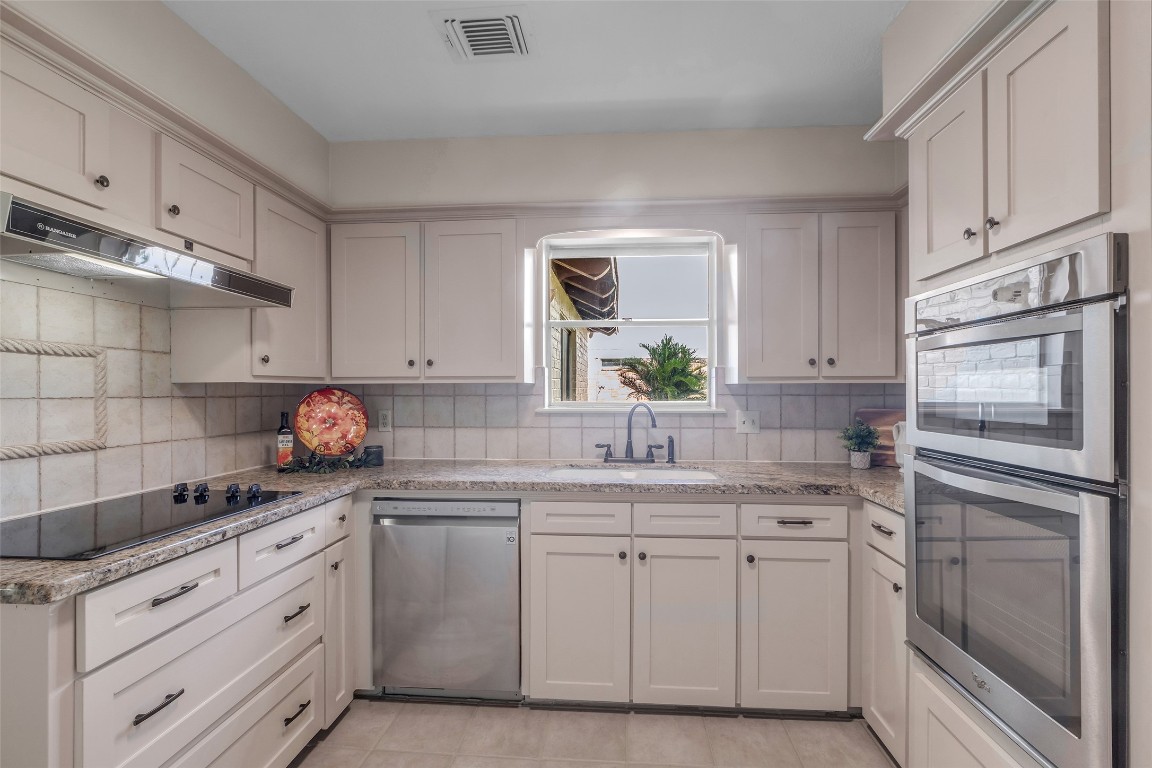 6415 Bayonne Drive Spring, TX 77389 - Photo 12 of 40 a kitchen with cabinets stainless steel appliances and a window