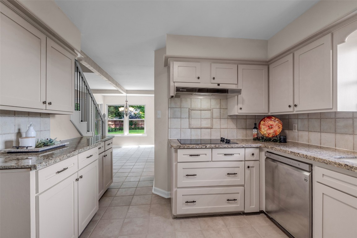 6415 Bayonne Drive Spring, TX 77389 - Photo 14 of 40 a kitchen with granite countertop white cabinets and white appliances