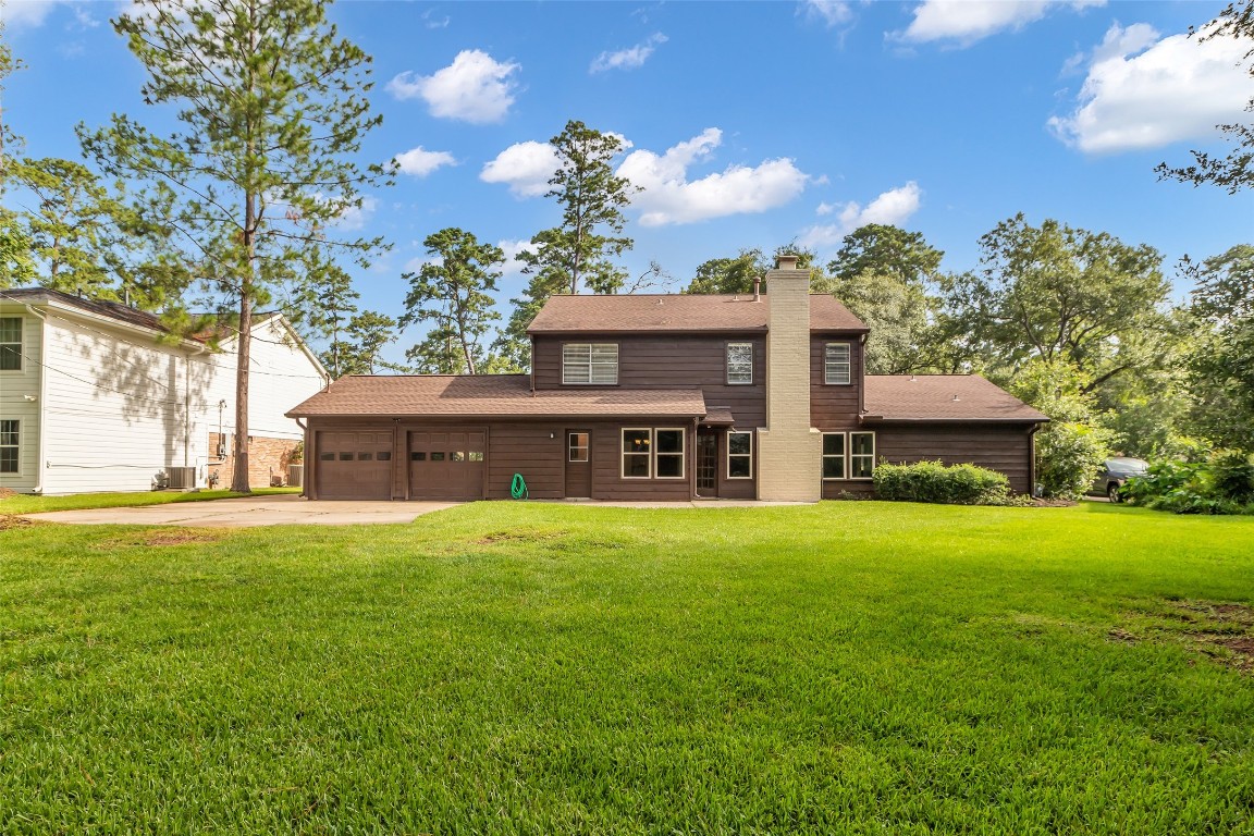 6415 Bayonne Drive Spring, TX 77389 - Photo 34 of 40 a view of a big house with a big yard and large tree