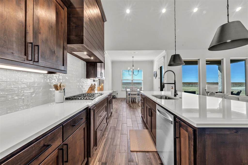6632 Buffalo Ridge Circle Godley, TX 76044 - Photo 11 of 37 a kitchen with stainless steel appliances granite countertop a sink a stove and a wooden floors