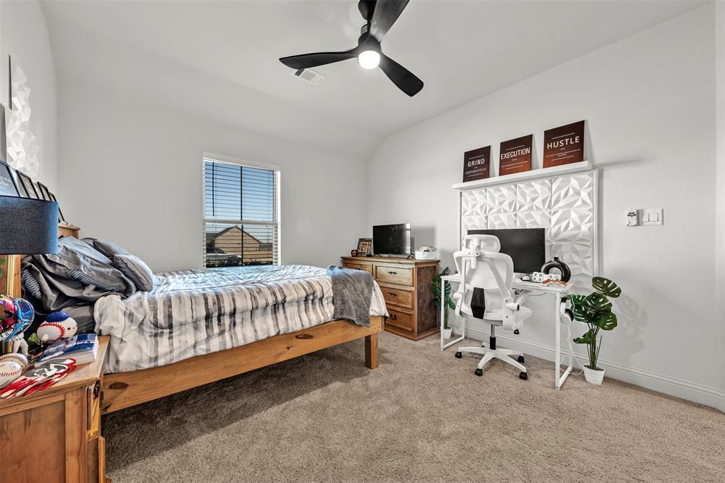 6632 Buffalo Ridge Circle Godley, TX 76044 - Photo 22 of 37 a bedroom with bed and a fireplace