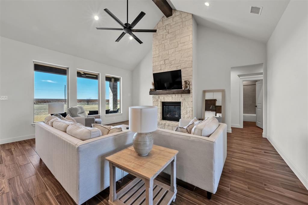 6632 Buffalo Ridge Circle Godley, TX 76044 - Photo 9 of 37 a living room with furniture a fireplace and a flat screen tv