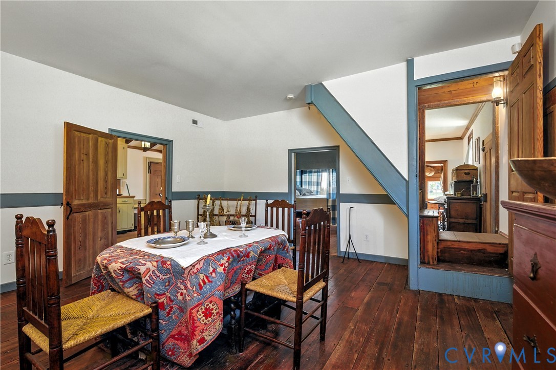 11826 Colonial Trail West Spring Grove, VA 23881 - Photo 14 of 42 a bedroom with a bed a table and wooden floor