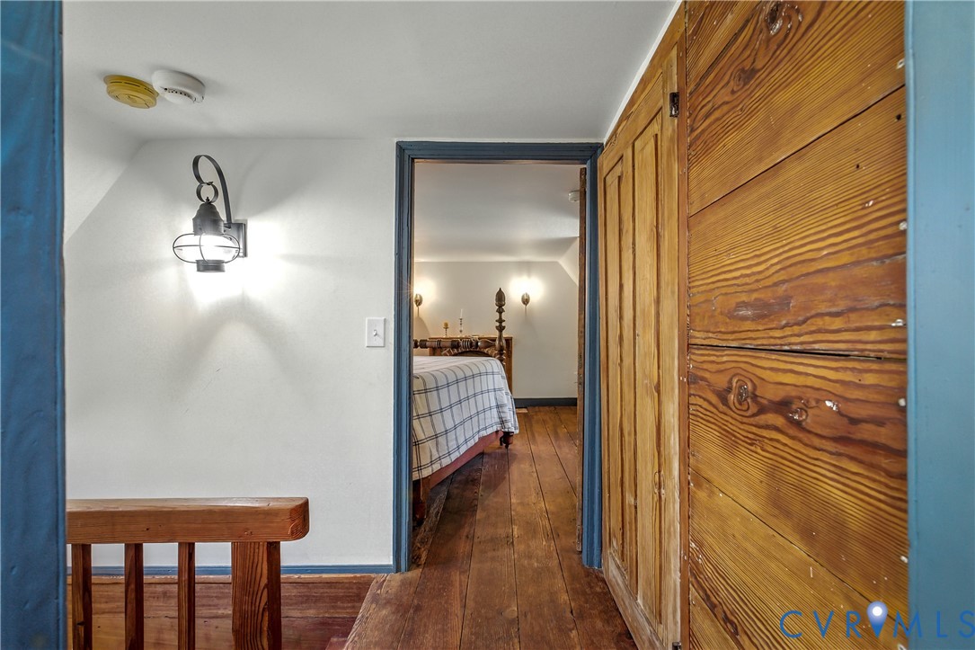 11826 Colonial Trail West Spring Grove, VA 23881 - Photo 22 of 42 a view of a hallway with wooden floor and a bathroom