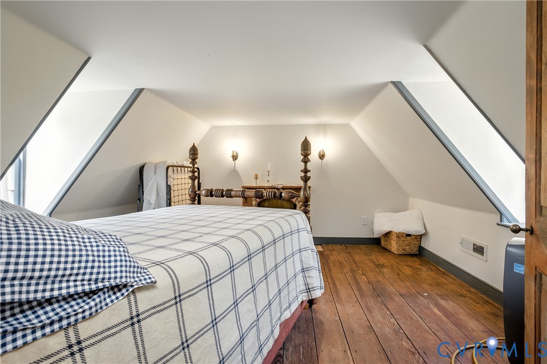 11826 Colonial Trail West Spring Grove, VA 23881 - Photo 23 of 42 a bedroom with a bed and a lamp on dresser
