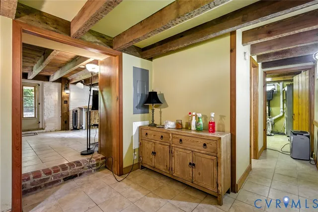 a view of a hallway with a livingroom and furniture