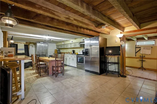 a large kitchen with a table and chairs