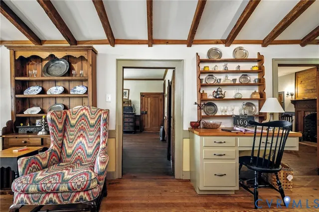 a kitchen with stainless steel appliances granite countertop a refrigerator a stove and white cabinets with wooden floor