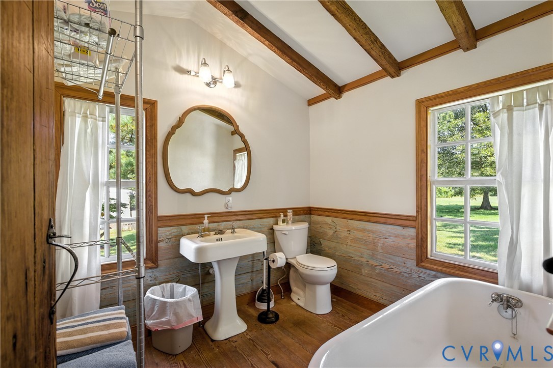 11826 Colonial Trail West Spring Grove, VA 23881 - Photo 9 of 42 a bathroom with a granite countertop toilet a sink and a mirror