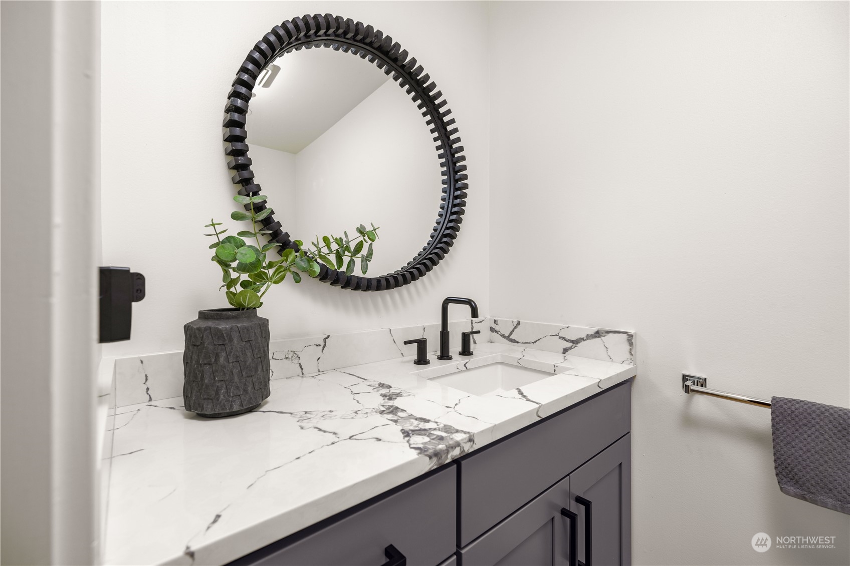 97 South Jackson Street, Unit 507 Seattle, WA 98104 - Photo 13 of 30 a bathroom with a sink and a mirror