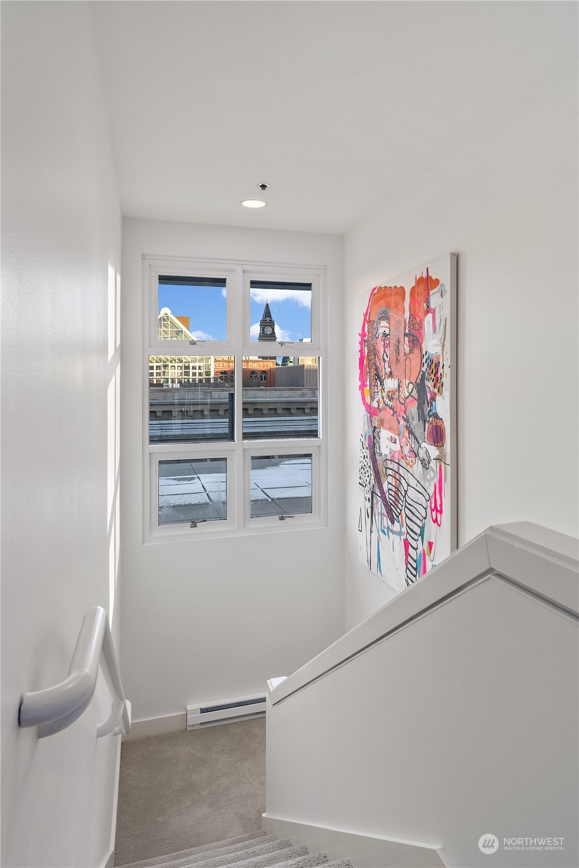 97 South Jackson Street, Unit 507 Seattle, WA 98104 - Photo 14 of 30 a view of a hallway with paintings on the wall
