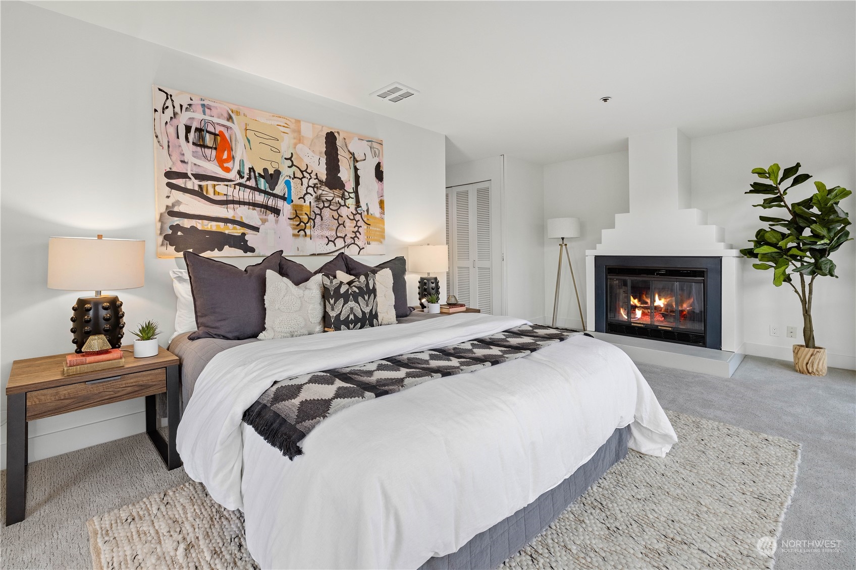 97 South Jackson Street, Unit 507 Seattle, WA 98104 - Photo 16 of 30 a bedroom with a bed and a fireplace