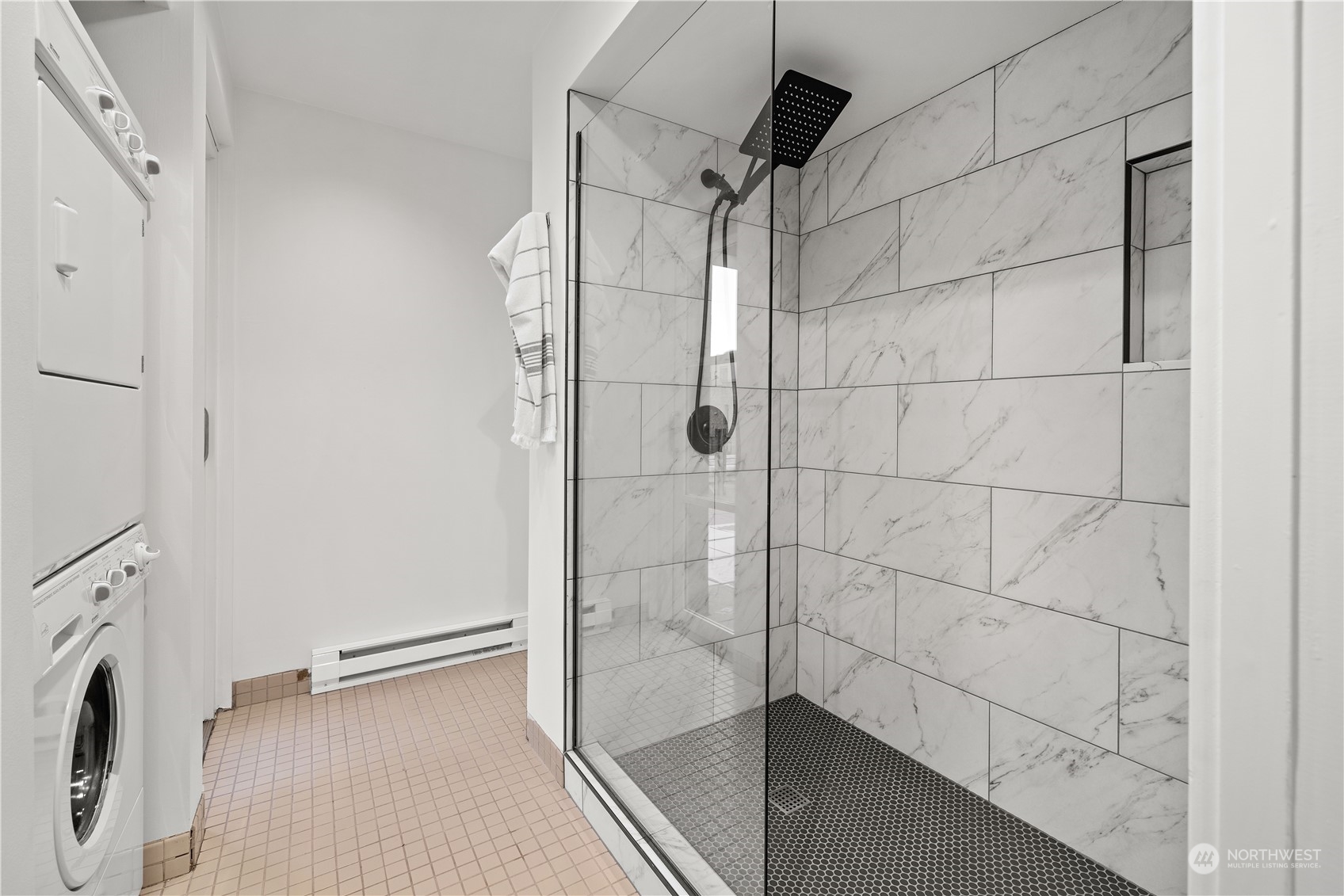 97 South Jackson Street, Unit 507 Seattle, WA 98104 - Photo 20 of 30 a bathroom with a glass shower door