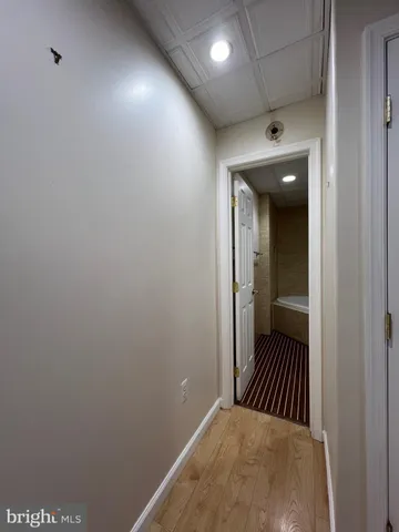 a view of a hallway with a room