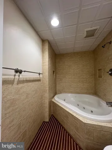 a bathroom with a bathtub and shower
